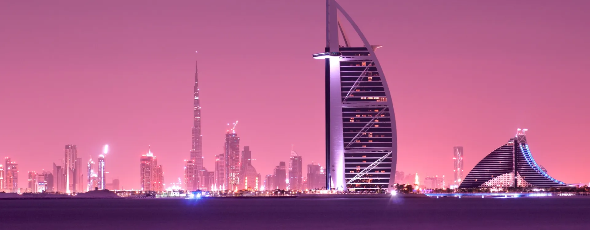 Dubai skyline at nightfall, illuminated Burj Al Arab and Burj Khalifa